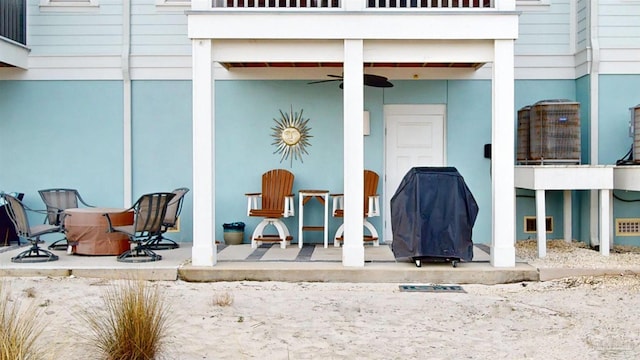 property entrance featuring ceiling fan, a patio, and a balcony