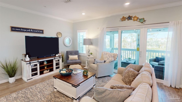 living room featuring crown molding and light wood-type flooring