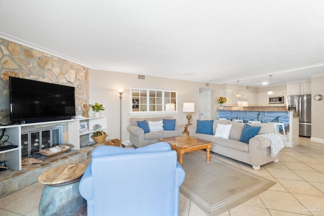 1111 Ft Pickens Rd Unit 111, Pensacola Beach, FL 32561 - living room featuring ornamental molding, light tile patterned flooring, and a stone fireplace