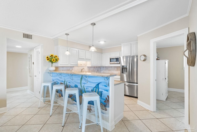 1111 Ft Pickens Rd Unit 111, Pensacola Beach, FL 32561 - kitchen with appliances with stainless steel finishes, a breakfast bar, tasteful backsplash, light tile patterned floors, and white cabinetry