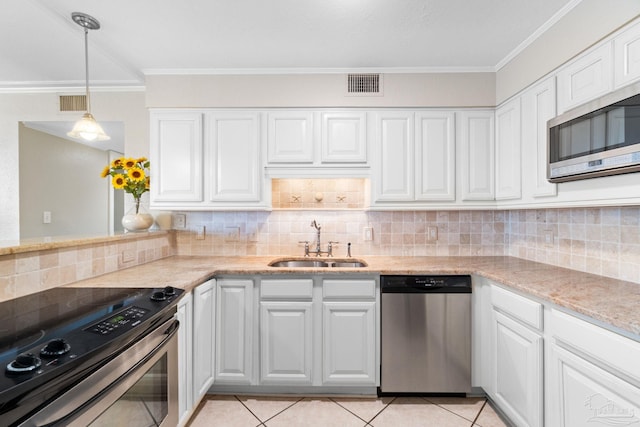 1111 Ft Pickens Rd Unit 111, Pensacola Beach, FL 32561 - kitchen featuring appliances with stainless steel finishes, ornamental molding, tasteful backsplash, white cabinetry, and light stone counters