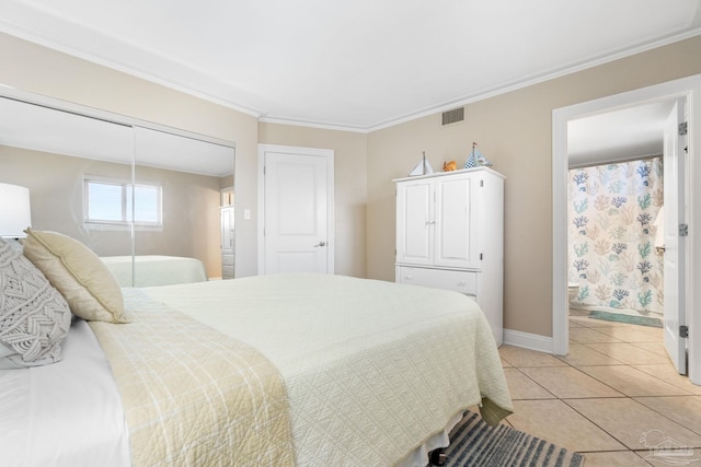 1111 Ft Pickens Rd Unit 111, Pensacola Beach, FL 32561 - bedroom with light tile patterned flooring, a closet, and ornamental molding