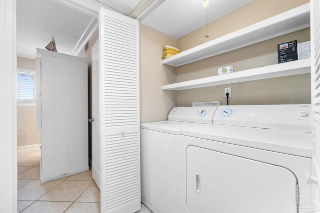 1111 Ft Pickens Rd Unit 111, Pensacola Beach, FL 32561 - laundry room featuring washer and dryer and light tile patterned floors