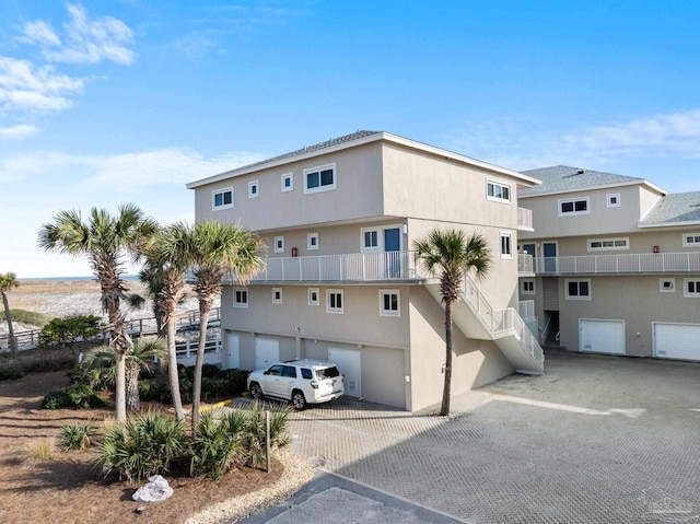 view of property featuring an attached garage and driveway