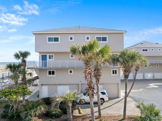 1111 Ft Pickens Rd Unit 111, Pensacola Beach, FL 32561 - rear view of house featuring decorative driveway and a garage