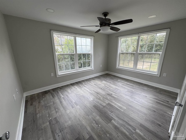 spare room with hardwood / wood-style flooring and ceiling fan