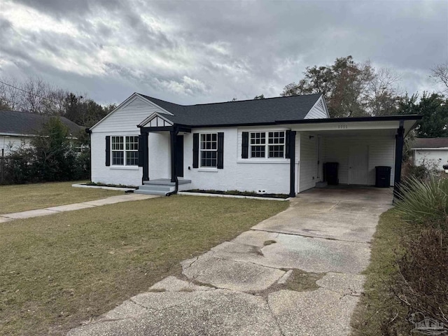 single story home featuring a front lawn and a carport