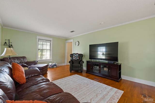 living room with hardwood / wood-style flooring and ornamental molding