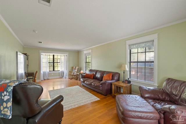 living room with crown molding and light wood-type flooring