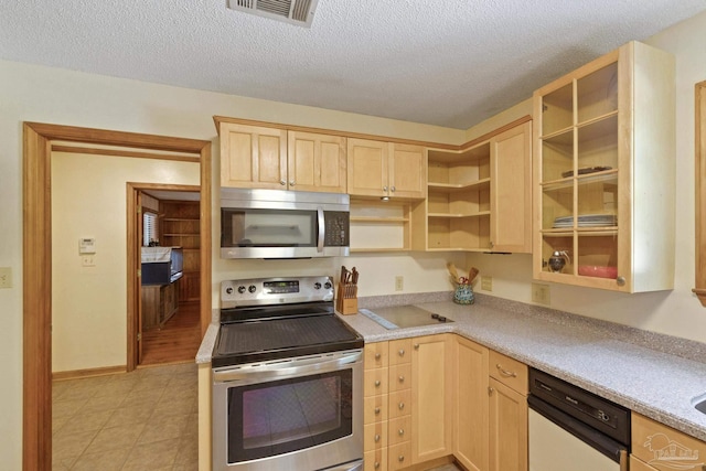 kitchen featuring visible vents, light brown cabinets, appliances with stainless steel finishes, and light countertops