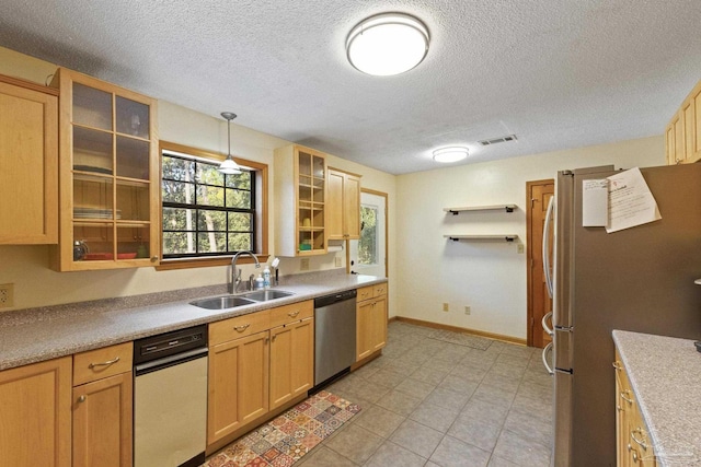 kitchen featuring appliances with stainless steel finishes, a textured ceiling, open shelves, and a sink
