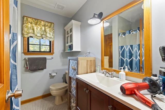 bathroom featuring vanity, toilet, a shower with shower curtain, and tile patterned flooring