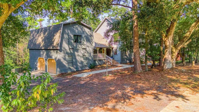 view of front of house with a porch and a garage