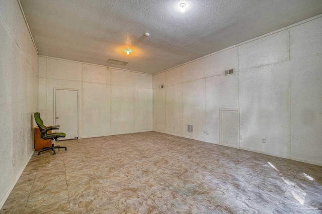unfurnished room featuring a textured ceiling and visible vents