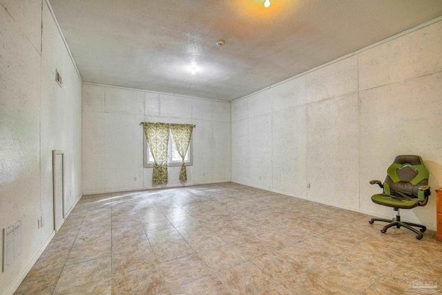 unfurnished room with a textured ceiling