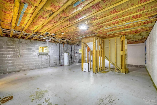 unfinished below grade area with concrete block wall and water heater