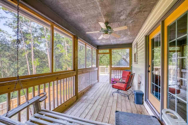 sunroom / solarium featuring ceiling fan