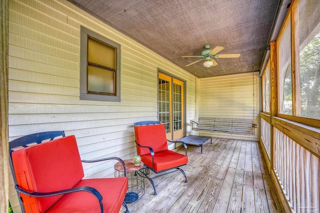 sunroom featuring ceiling fan