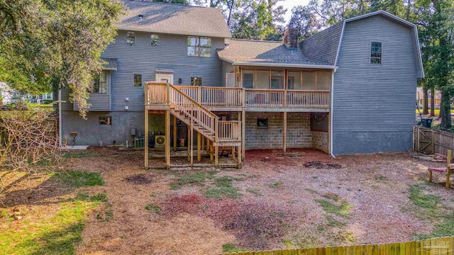 back of house featuring a wooden deck, stairway, a chimney, roof with shingles, and fence