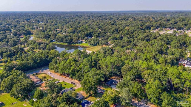 birds eye view of property featuring a wooded view and a water view