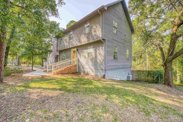 back of house with fence and a yard