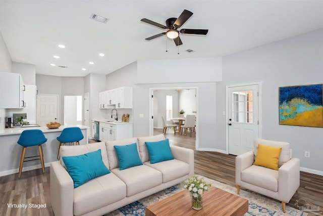 living room with hardwood / wood-style flooring, sink, and ceiling fan