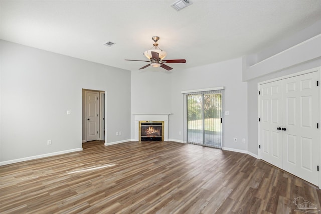 unfurnished living room with wood-type flooring, ceiling fan, and a textured ceiling