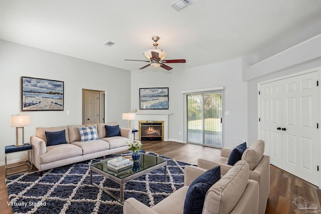 living room with hardwood / wood-style flooring and ceiling fan