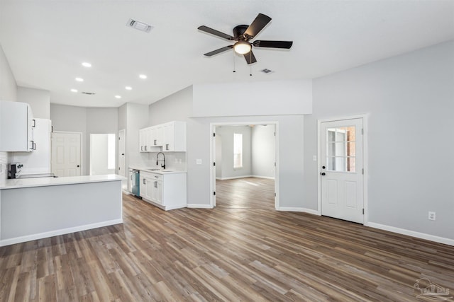 unfurnished living room with ceiling fan, sink, and dark hardwood / wood-style floors