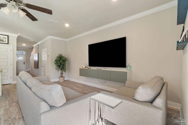 living room featuring hardwood / wood-style flooring, ceiling fan, and crown molding