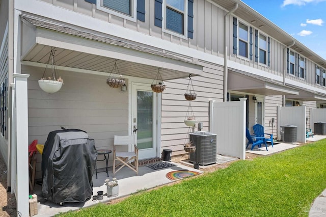 back of house with a lawn and central AC