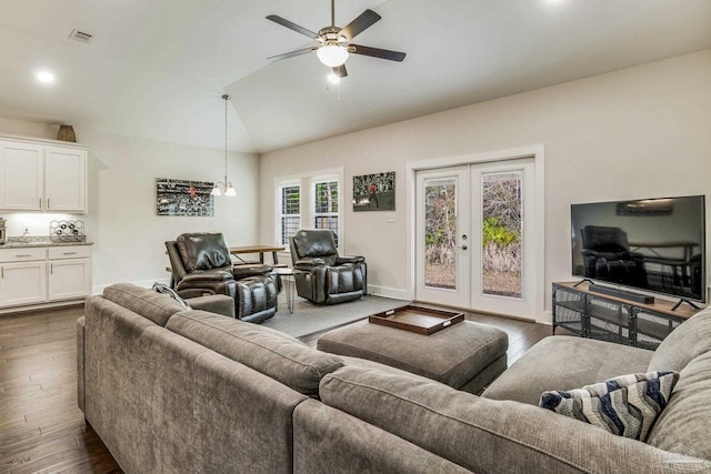 living room featuring lofted ceiling, dark wood-type flooring, french doors, and ceiling fan