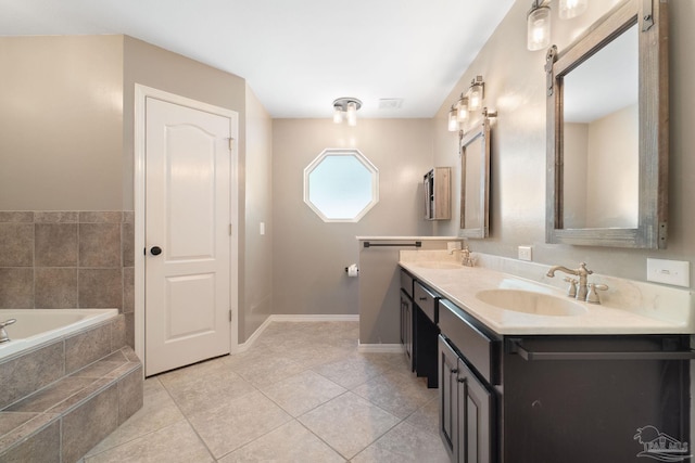 bathroom featuring vanity, tile patterned floors, and tiled tub