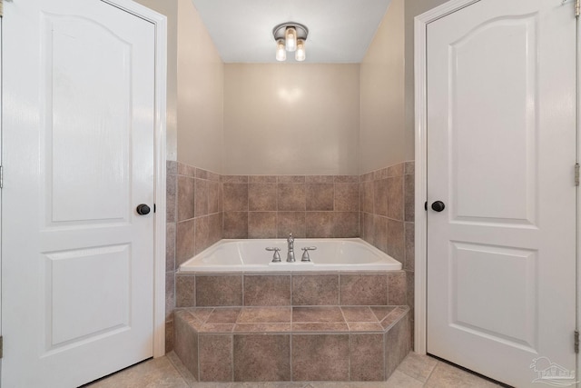 bathroom with tile patterned floors and tiled bath