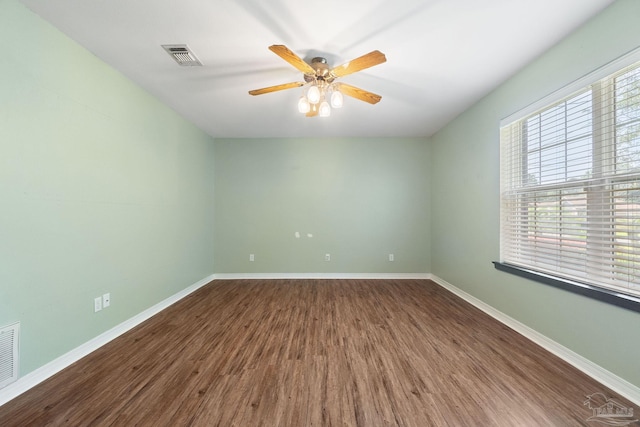 spare room featuring wood-type flooring and ceiling fan