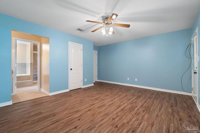 unfurnished bedroom featuring dark wood-type flooring and ceiling fan