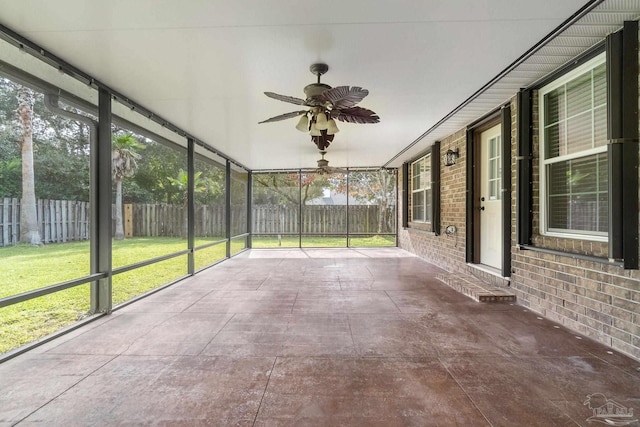 unfurnished sunroom featuring ceiling fan