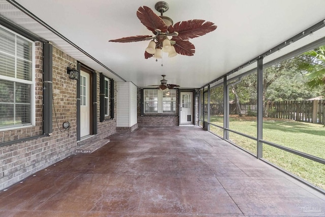 unfurnished sunroom with a wealth of natural light and ceiling fan