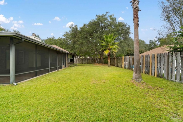 view of yard featuring a sunroom