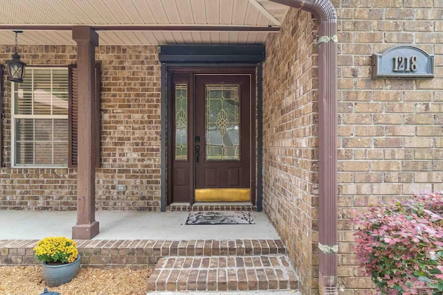 view of exterior entry featuring a porch