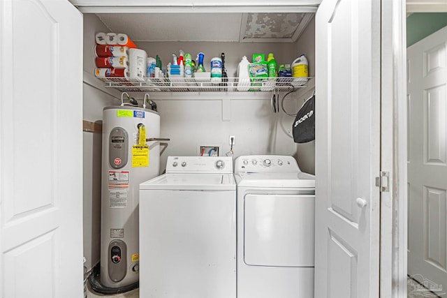 clothes washing area with washer and clothes dryer and electric water heater