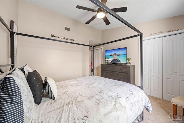 carpeted bedroom featuring multiple closets, ceiling fan, and lofted ceiling