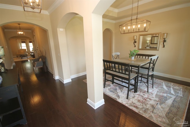 4135 Dundee Crossing Dr, Pace, FL 32571 - dining room featuring arched walkways, wood finished floors, a chandelier, ornamental molding, and baseboards