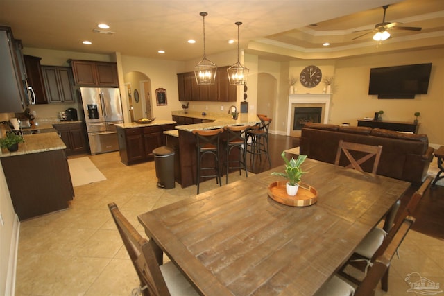 4135 Dundee Crossing Dr, Pace, FL 32571 - dining room featuring arched walkways, ceiling fan, light tile patterned flooring, recessed lighting, and a fireplace