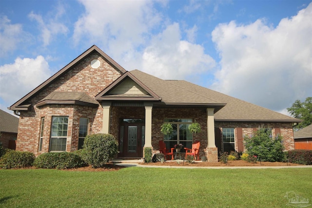 4135 Dundee Crossing Dr, Pace, FL 32571 - craftsman-style home featuring brick siding, a front lawn, and a porch