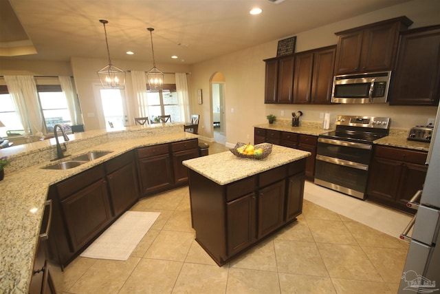 4135 Dundee Crossing Dr, Pace, FL 32571 - kitchen featuring stainless steel appliances, a sink, arched walkways, recessed lighting, and healthy amount of natural light