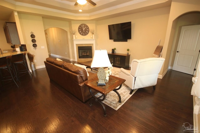 4135 Dundee Crossing Dr, Pace, FL 32571 - living area with arched walkways, ornamental molding, a tray ceiling, and dark wood-style floors