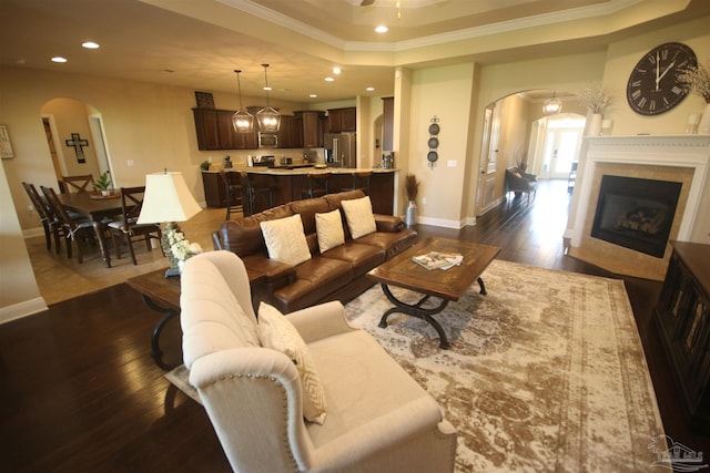 4135 Dundee Crossing Dr, Pace, FL 32571 - living room featuring arched walkways, a tray ceiling, recessed lighting, crown molding, and baseboards