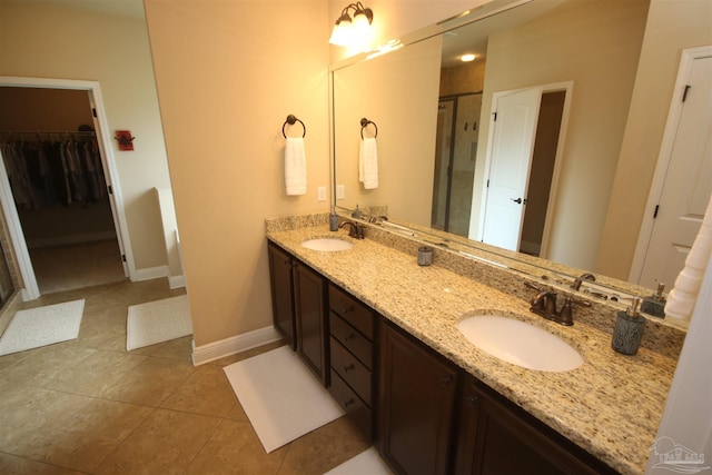 4135 Dundee Crossing Dr, Pace, FL 32571 - full bathroom featuring tile patterned floors, double vanity, a stall shower, and a walk in closet