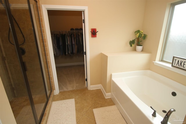 4135 Dundee Crossing Dr, Pace, FL 32571 - bathroom with a bath, a shower stall, a walk in closet, and tile patterned flooring